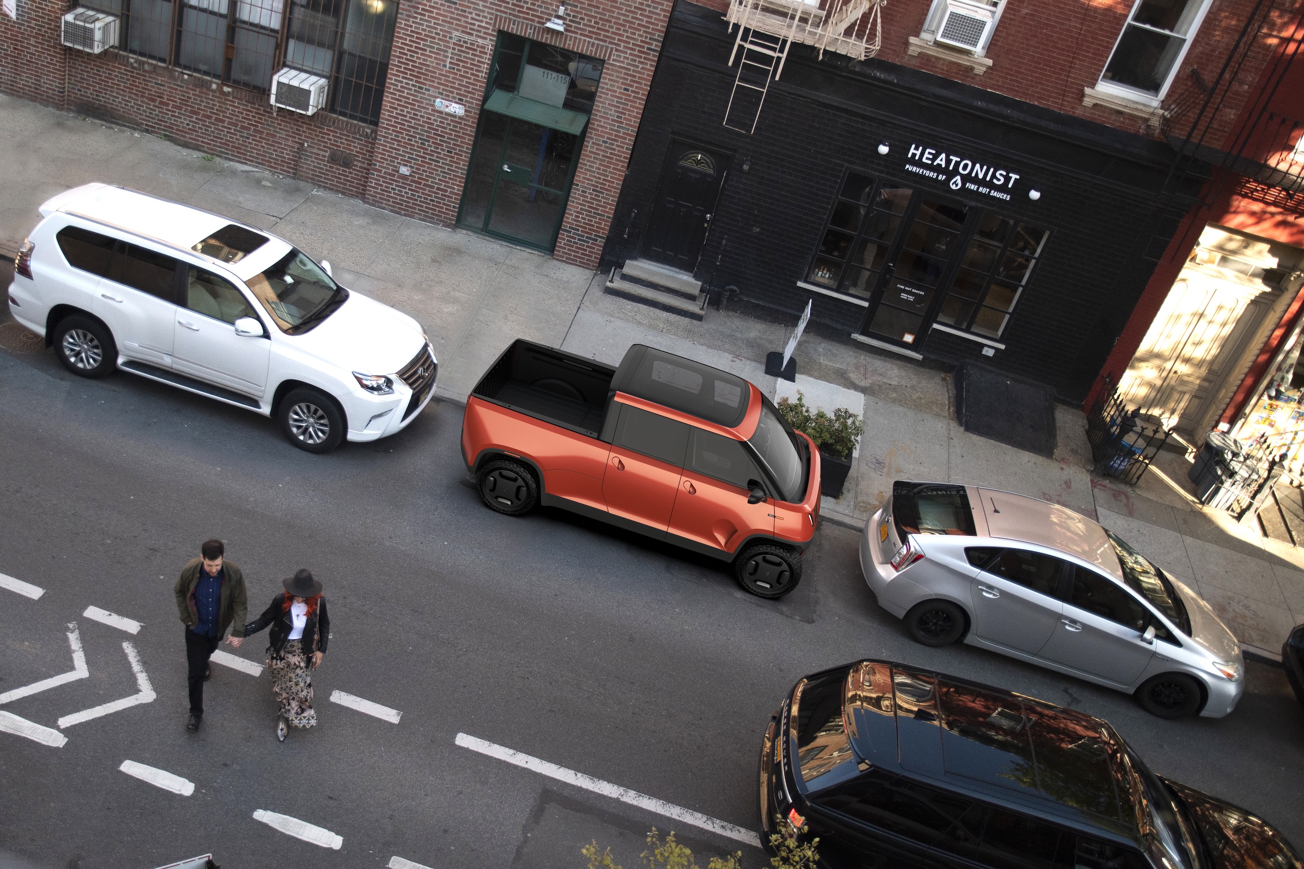 A top down view of a couple walking on a San Francisco street with an orange TELO MT1 behind them tightly parked in between two other cars.